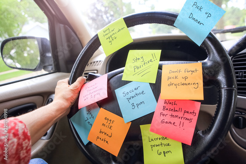 Steering wheel covered in notes as a reminder of errands to do photo