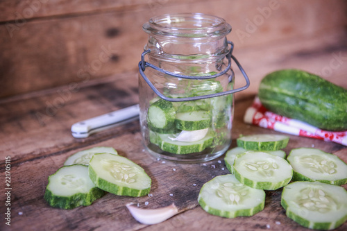 Sliced cucumbers fresh from the garden and ingredients to make refrigerator pickles