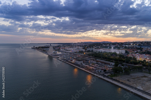 Aerial view of the Belém neighborhood and the Tagus River (Rio Tejo) in the city of Lisbon at sunset; Concept for travel in Portugal and visit Lisbon