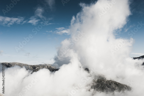 White clouds over the mountains top. Kjerag mountain, Norway.