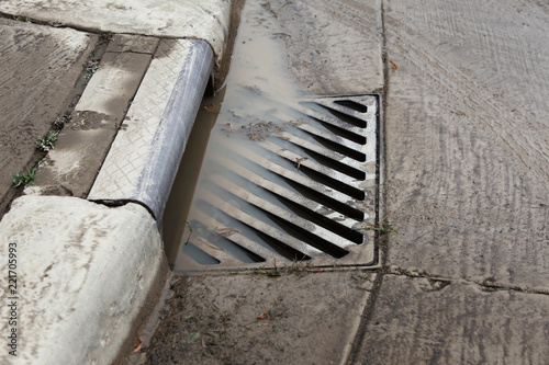 Stormwater filling a flooded sewer drain to the top