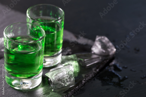 Two glasses of absinthe and melted ice cubes
