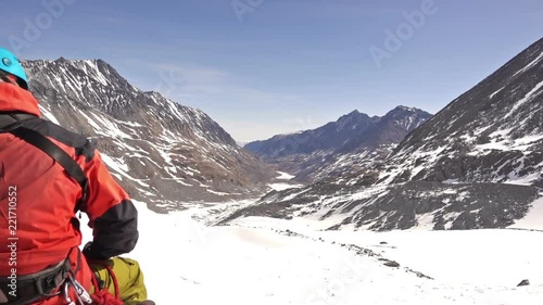 Climber resting on a glacier before climbing to the top of the mountain. Altai, in November 2015, the foot of the mountain Aktru, altitude 4000