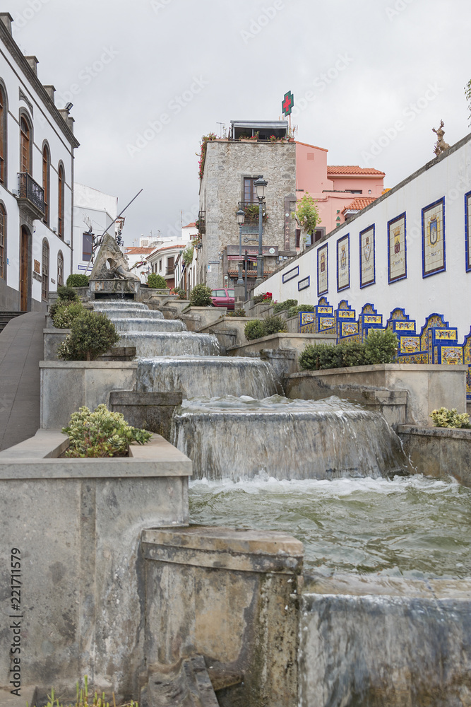 Firgas, Spain. September, 4 th 2018: Water fall in a road of the village.