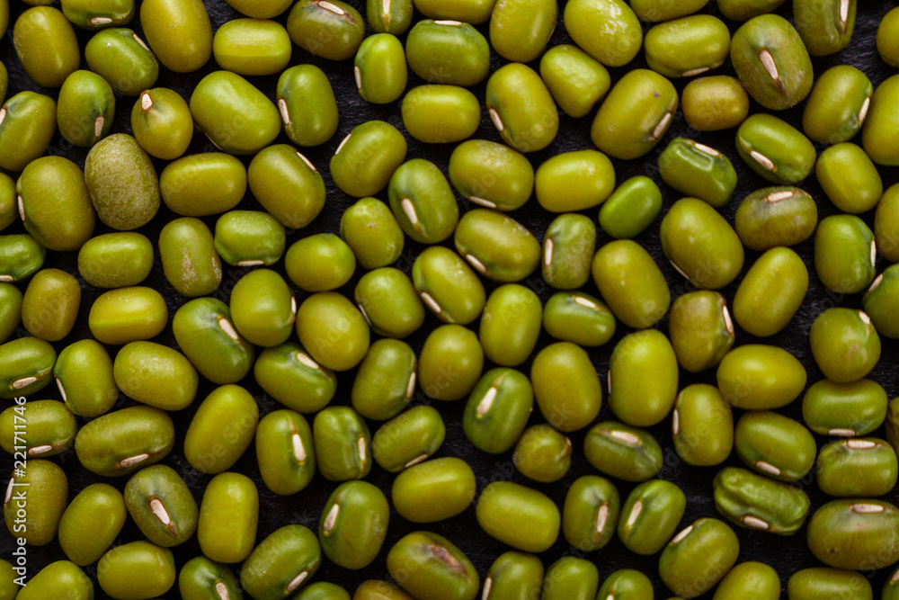 fresh Mung beans on a dark stone background fresh Mung beans on a dark stone background