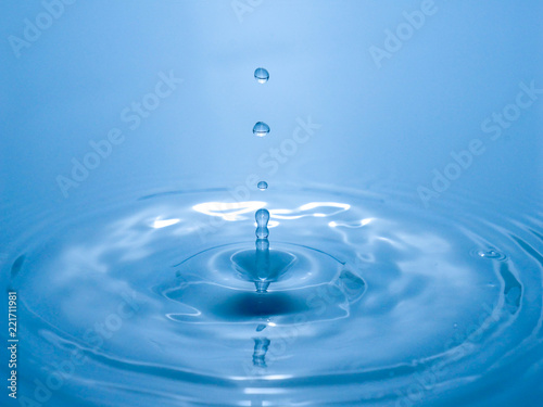 close up drop of water on blue background