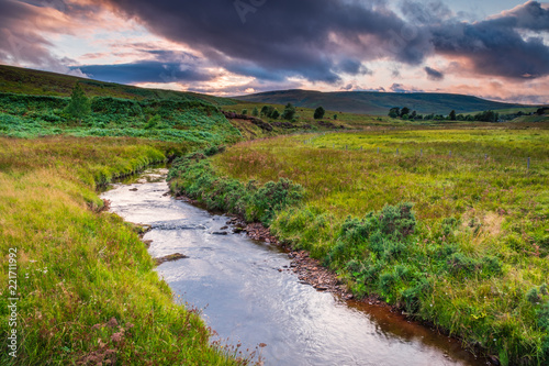 River Rede in Redesdale / Flowing from the Cheviot Hills past Whitelee Moor in Northumberland National Park the river begins its journey downstream photo