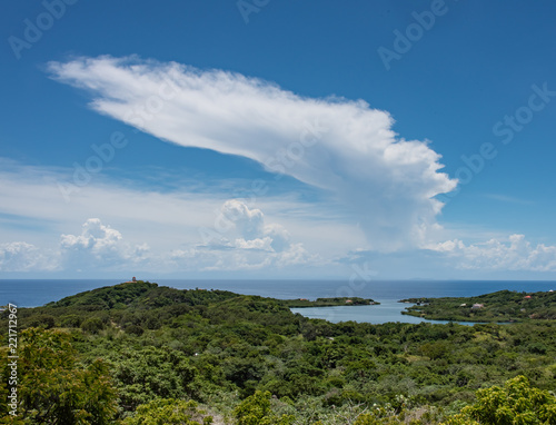 Cumulonimbus Anvil Cloud Over Caribbean Sea and Green Landscape Foreground