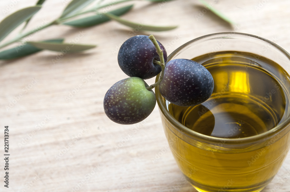 olive oil in a glass olive tree branch and olives olive oil in a glass olive tree branch and olives