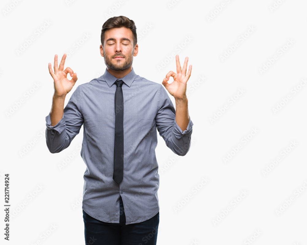Young handsome business man over isolated background relax and smiling with eyes closed doing meditation gesture with fingers. Yoga concept. Young handsome business man over isolated background relax and smiling with eyes closed doing meditation gesture with fingers. Yoga concept.