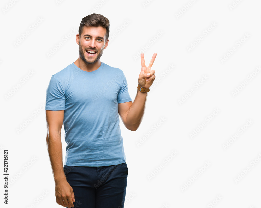 Young handsome man over isolated background smiling with happy face winking at the camera doing victory sign. Number two. Young handsome man over isolated background smiling with happy face winking at the camera doing victory sign. Number two.