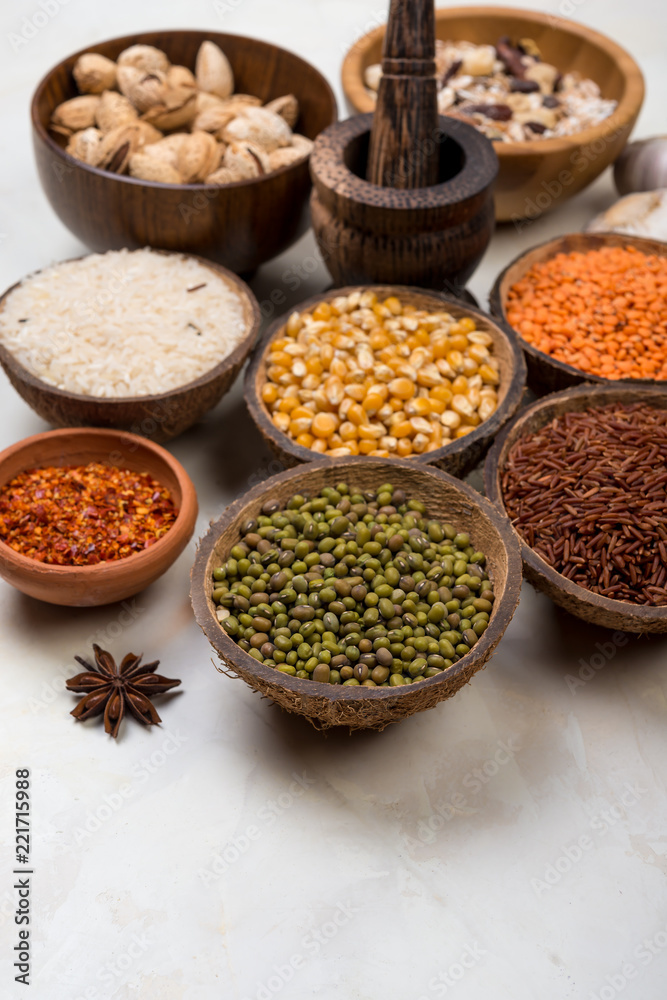 cereals, seeds, beans, grains in a bowls on white table