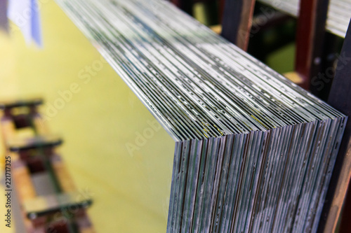 Sheets of Factory manufacturing tempered clear float glass panels cut to size © Aleksei