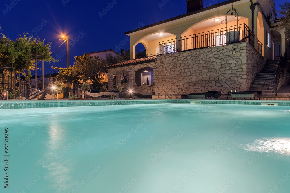 Holiday home with swiiming pool at night