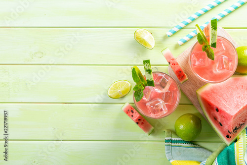 Watermelon lemonade with lime and mint, wood background, copy space