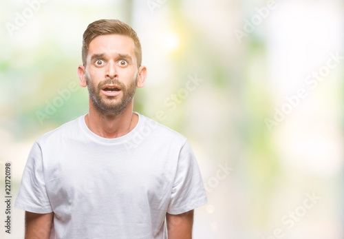 Young handsome man over isolated background afraid and shocked with surprise expression, fear and excited face.