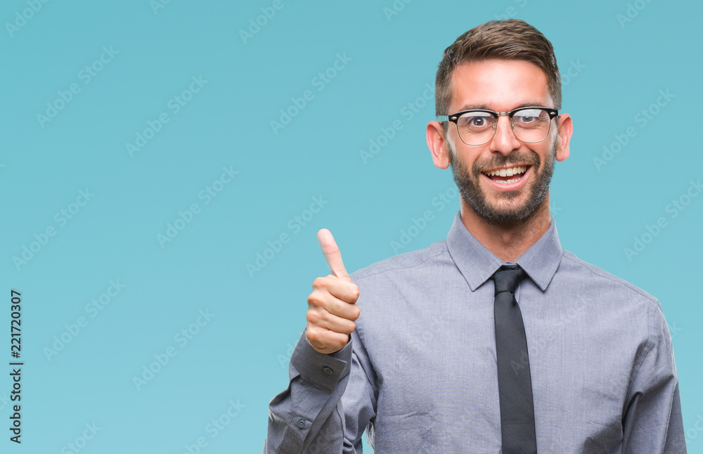 Young handsome business man over isolated background doing happy thumbs up gesture with hand. Approving expression looking at the camera with showing success. Young handsome business man over isolated background doing happy thumbs up gesture with hand. Approving expression looking at the camera with showing success.