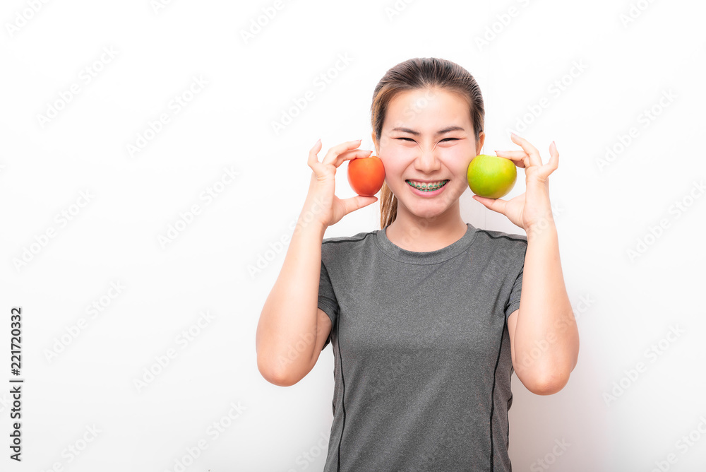 Asian woman having fun with green apple and tomato Asian woman having fun with green apple and tomato