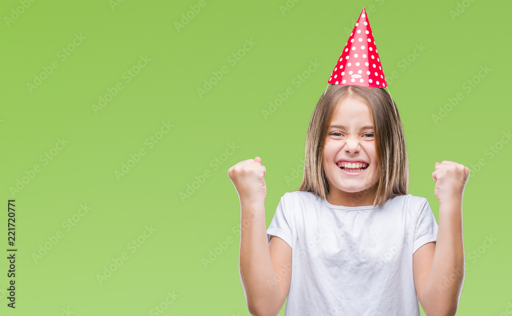 Young beautiful girl wearing birthday cap over isolated background celebrating surprised and amazed for success with arms raised and open eyes. Winner concept. Young beautiful girl wearing birthday cap over isolated background celebrating surprised and amazed for success with arms raised and open eyes. Winner concept.