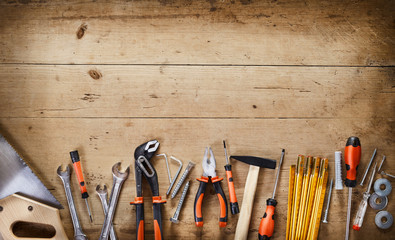 Rustic border over wood of assorted hand tools