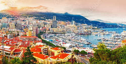 Principality of Monaco. Picturesque panoramic view on Monaco on sunset hour. View on apartment building, casino, port with luxury yachts. Monaco is popular travel destination for gambling. 