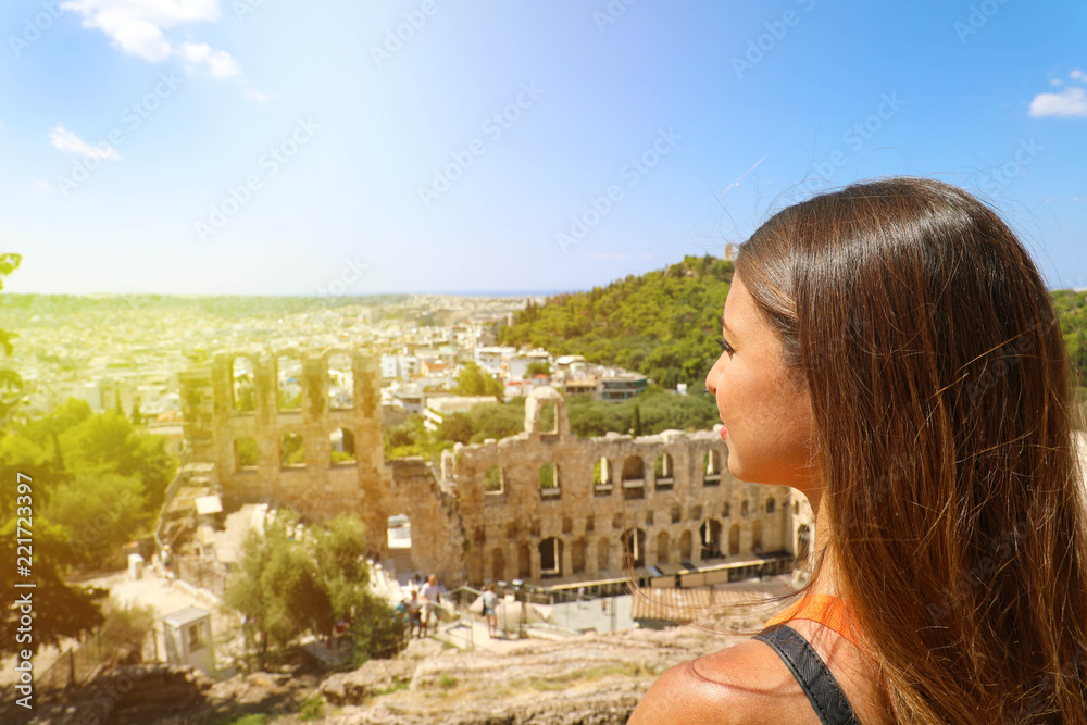 Young woman on the Acropolis of Athens, Greece. Tourist female looking to ancient theater and Athens landscape in a summer day on the Acropolis. Young woman on the Acropolis of Athens, Greece. Tourist female looking to ancient theater and Athens landscape in a summer day on the Acropolis.
