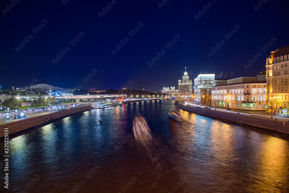 Stalin Skyscraper on Kotelnicheskaya Embankment of the Moscow River. Night shot of Moscow river reflection. Panorama view of Moscow city, Russia