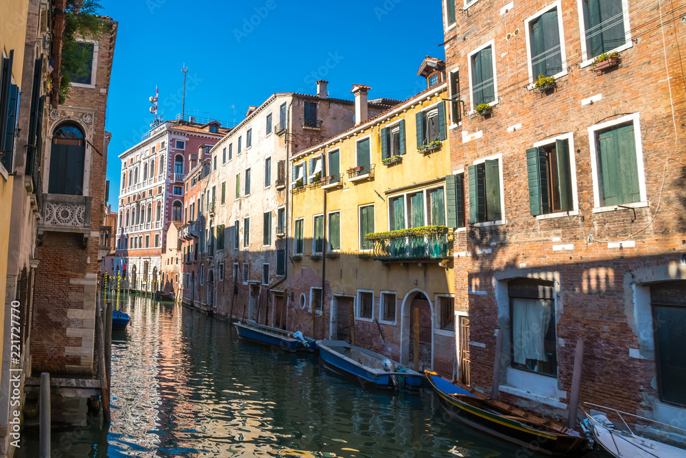 boats in the narrow canals of Venice, Italy