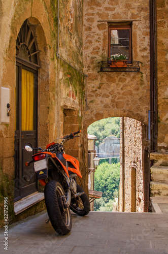 Motorbike on the old street of Pitigliano, Italy