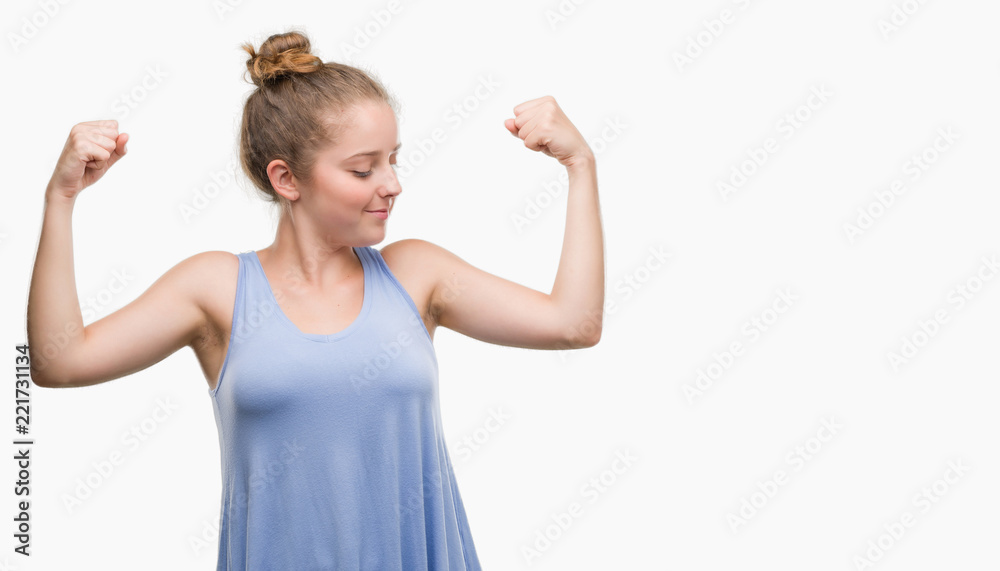 Young blonde woman showing arms muscles smiling proud. Fitness concept. Young blonde woman showing arms muscles smiling proud. Fitness concept.