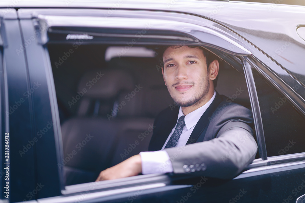 handsome confident businessman sitting in car to business trip
