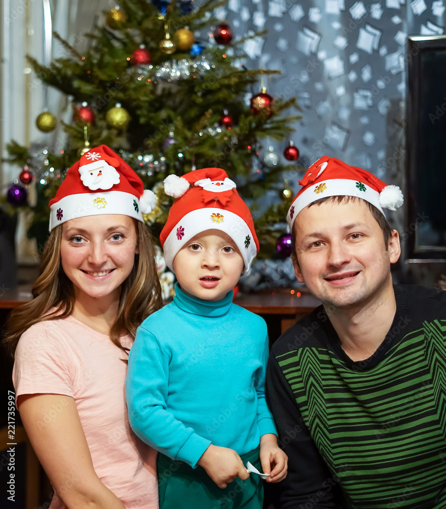 Smiling happy family having fun with Christmas presents at home Smiling happy family having fun with Christmas presents at home