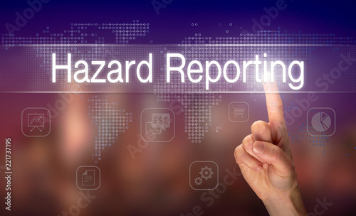 A hand selecting a Hazard Reporting business concept on a clear screen with a colorful blurred background.