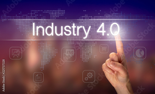 A hand selecting a Industry 4.0 business concept on a clear screen with a colorful blurred background.
