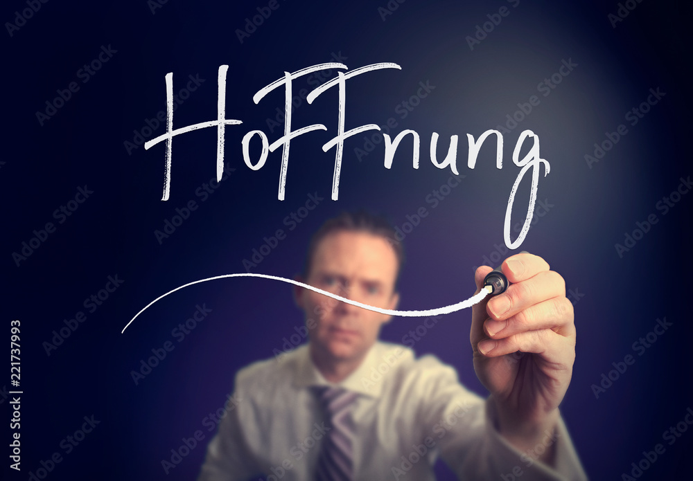 A businessman writing a Hope A businessman writing a Hope