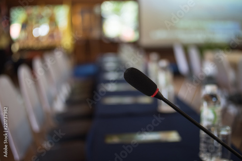 Close up microphone in seminar room, blurred background room