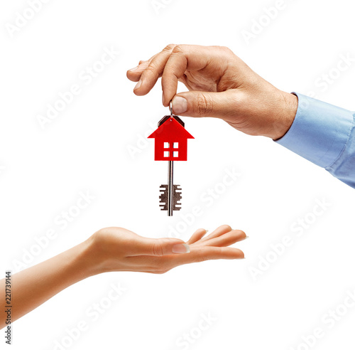 Man's hand giving the house key to woman's hand isolated on white background. Close up. High resolution product