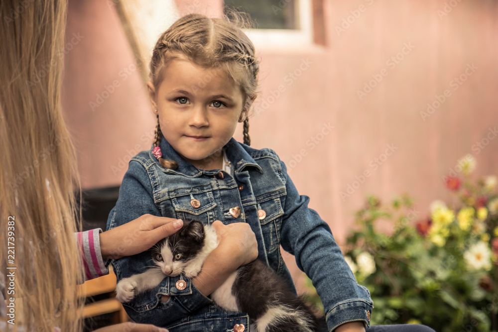 Beautiful  child kid girl holding pet kitten concept animals care 