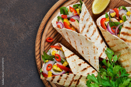 Taco - traditional dish of Mexican cuisine. Mexican tacos with beef, vegetables and sauce. Top view.