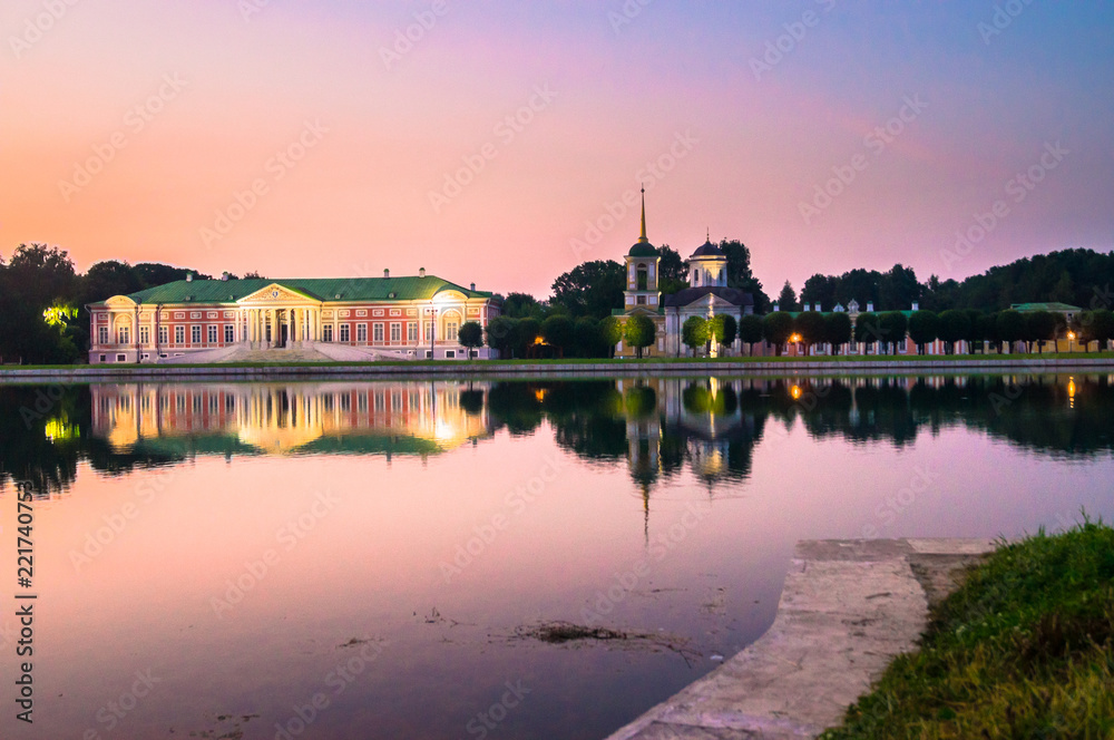 Fototapeta premium Admirable pink sunset sky over the architectural ensemble of the State reserve museum Kuskovo, former aristocratic summer country estate of the russian nobility of the 18th century. Moscow. Russia.