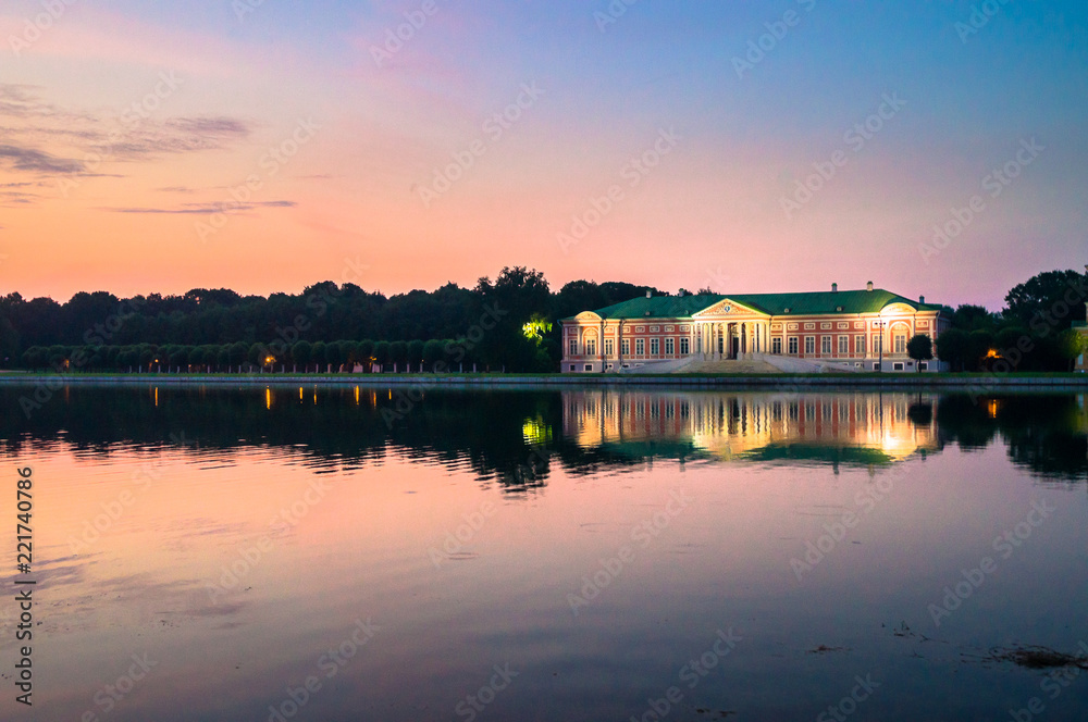 Admirable pink sunset sky over the architectural ensemble of the State reserve museum Kuskovo, former aristocratic summer country estate of the russian nobility of the 18th century. Moscow. Russia.