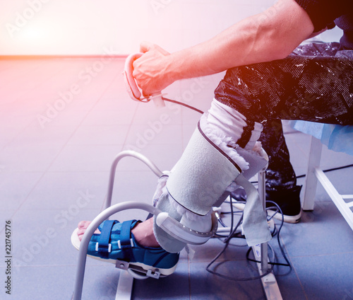 Patient on CPM (continuous passive range of motion) machines. Device to provide anatomically correct motion to both the ankle and subtalar joints. photo