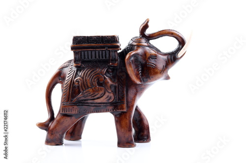 Brown Gold Black elephant made of resin like wooden carving with candle holder with white ivory. Stand on white background, Isolated, Art Model Thai Crafts, For decoration Like in the spa. Engraved pa