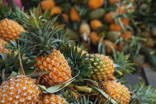 Background with a heap of ripe pineapples