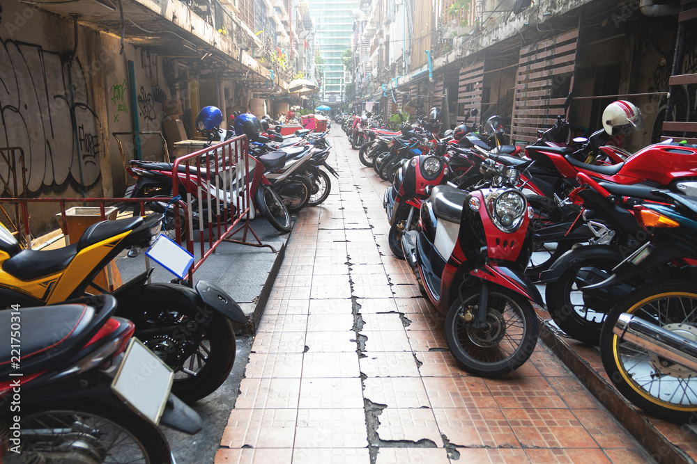Parked scooters and motorcycles on the Bangkok city street