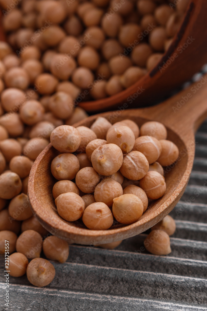 uncooked chickpeas on a wooden rustic background uncooked chickpeas on a wooden rustic background