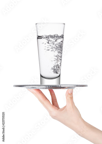 Hand holds tray with still water glass photo