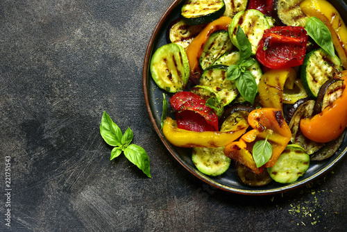 Grilled vegetables ( colorful bell pepper, zucchini, eggplant ) with basil and dry herbs.Top view.