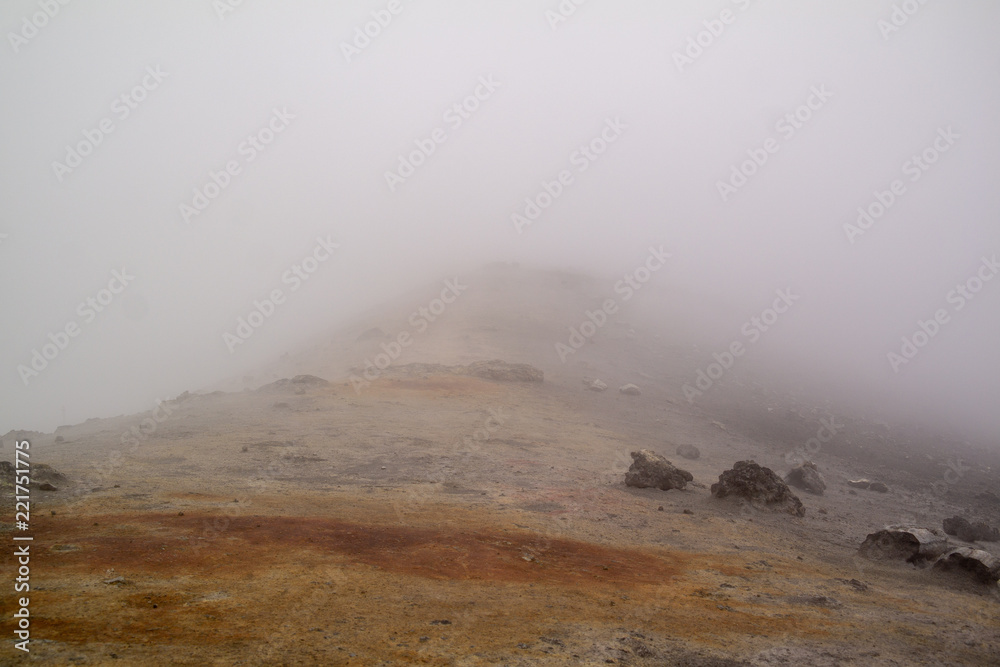 Etna vulcano surrealistic landscape mountain clouds fog lava stone 