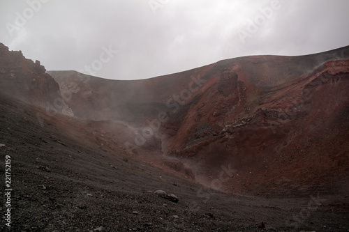 Etna vulcano surrealistic landscape mountain clouds fog lava stone 